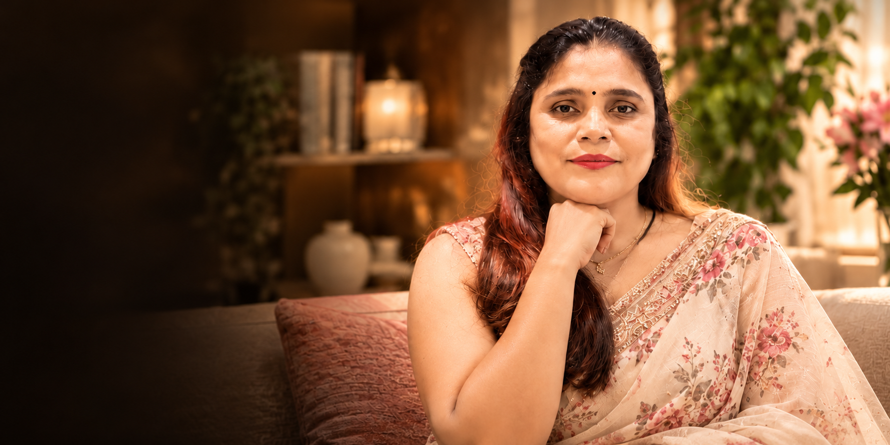 Pallavi seated in a warmly lit room